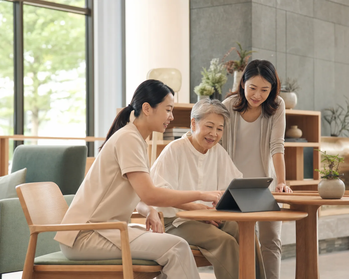 A resident, guardian, and care professional reviewing care information together